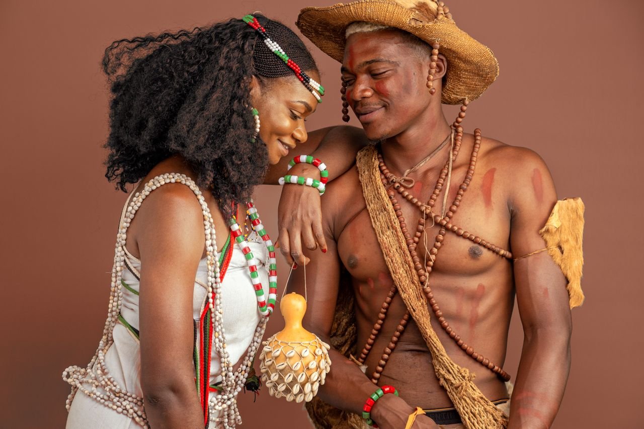 A couple in traditional African clothing sharing a joyful moment, showcasing rich cultural heritage.