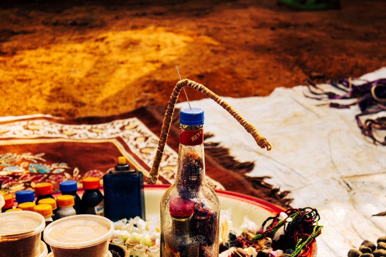 Mastering the First Impression: Your intriguing post title goes here Close-up of traditional items and a bottle at a market in Ngel Nyaki, Nigeria.